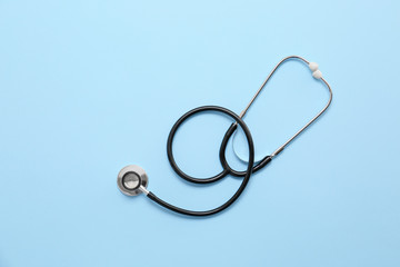 Stethoscope on color background. Cardiology concept