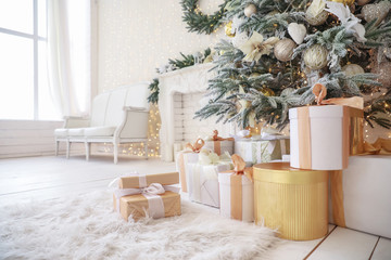 Beautiful decorated Christmas tree with gifts in living room