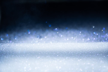 Glitter vintage lights background, the silver and black. Image defocused.