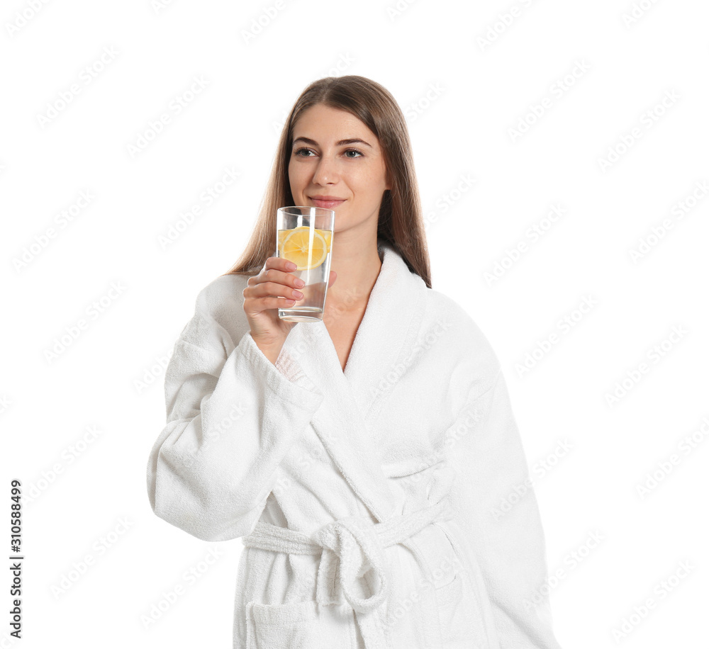 Wall mural Young woman drinking lemon water on white background