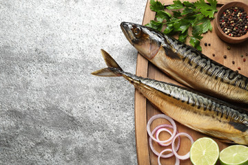 Tasty smoked fish on grey table, top view. Space for text