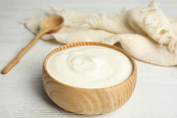 Obraz na płótnie Canvas Tasty organic yogurt on white wooden table