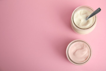 Tasty organic yogurt on pink background, flat lay. Space for text