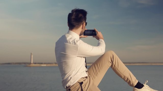 Mobile Photo.Pictures On Smartphone.Man Taking Mobile Photo.Man Holding Mobile Phone Taking Picture At Sunset.Close Up Attractive Male Happy Using Mobile App For Photo Or Video.