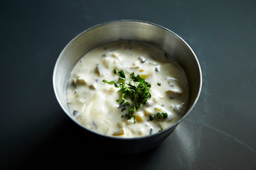 White cream sauce with dried parsley 