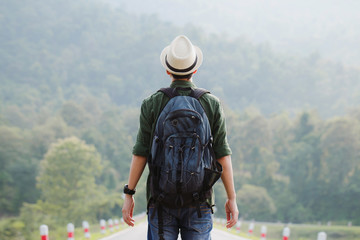 Fototapeta Young traveler wearing a hat with backpack hiking outdoor Travel Lifestyle and Adventure concept. obraz