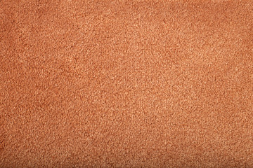 Carpet covering background. Pattern and texture of peach colour carpet. Copy space.