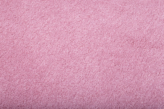 Carpet covering background. Pattern and texture of pink colour carpet. Copy space.