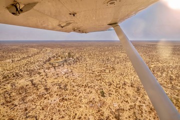Shot from a small safari charter plane, showing a panoramic view of a Botswana landscape, including dry waterholes, during the annual dry season in southern Africa. © Cheryl Ramalho