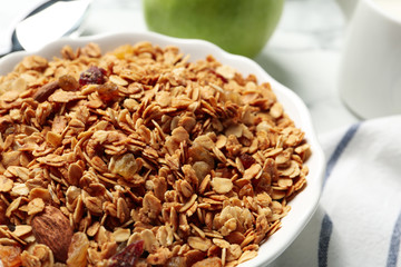 Tasty muesli with raisins on table, closeup. Healthy breakfast