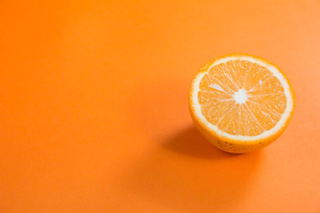 half cut orange side angle top view on orange background for orange products