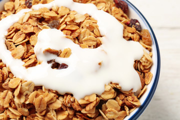 Muesli with yogurt in bowl, closeup. Delicious breakfast