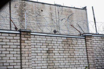 Prison or protected area. High brick walls with barbed wire.