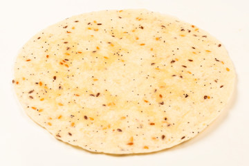 Pitta bread with seeds isolated on white