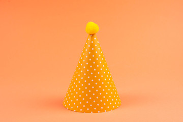 Colorful birthday caps on orange background.