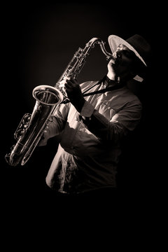 Saxophone Player in Concert - black and white isolated on black background