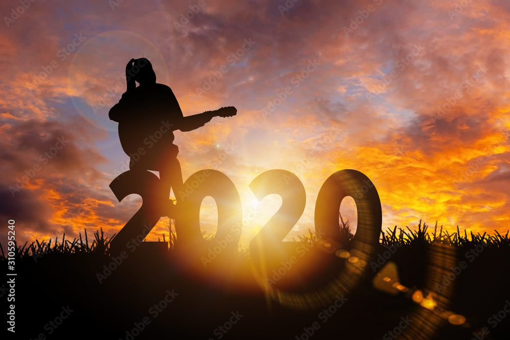 Wall mural 2020 new year : young woman playing guitar and relaxing with music on 2020 new year, happy new year 