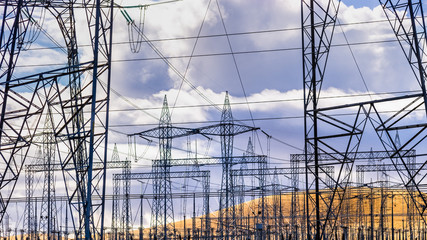 High voltage electricity towers and power lines at a substation in Central California; a substation...
