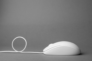 Modern wired computer mouse on grey background. Space for text