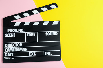 Fototapeta na wymiar Clapper board on color background, top view with space for text. Cinema production