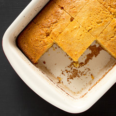 Homemade sweet Cornbread Ready to Eat on a black background, top view. Flat lay, overhead, from above. Close-up.