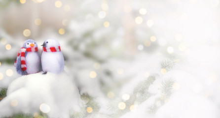 Two decorative penguins sit on the snow