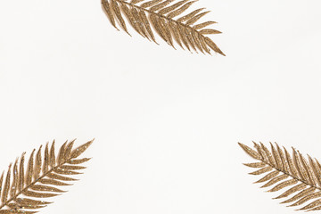 Golden leaves on white background. Flat lay, top view, copy space
