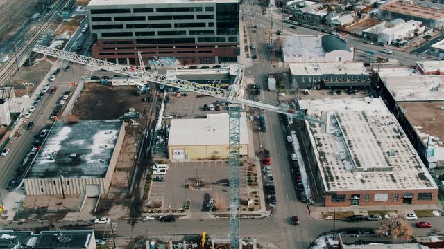 Drone aerial of tall construction crane on building site
