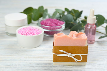 Natural handmade soap bar on white wooden table. Space for text