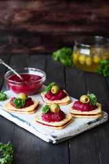 Beetroot relish on crackers. An original party snack.