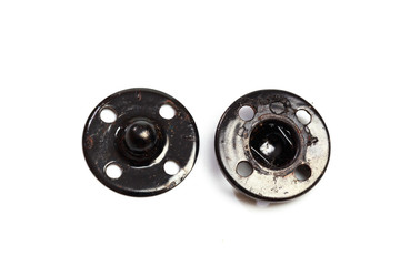 Obraz premium Close up of a group of metal Snap on Buttons on white background - Image