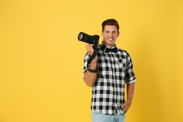 Professional photographer working on yellow background in studio. Space for text