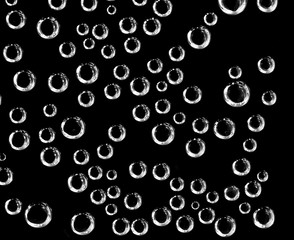 Air balls in water on a black background