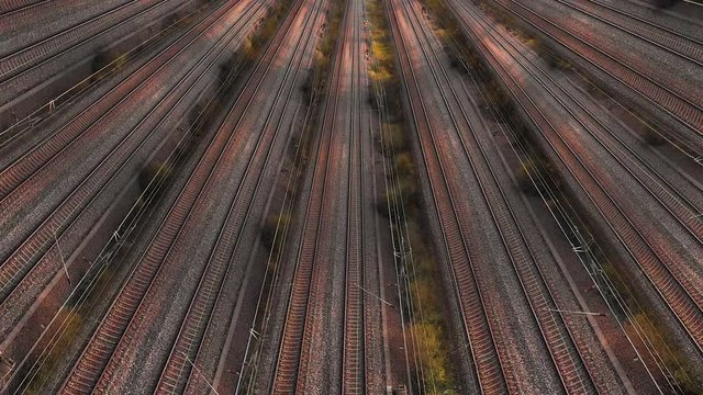 Drone above Pattern of Many trains passing by multiply rails, Aerial view above Dynamic rails tracks and trains. Manipulated video shows busy transportation system, rush time concept