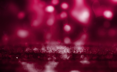 Hearts on a sparkling shiny background. Red abstract background. Blurry bokeh, neon light.