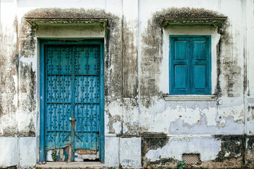 Fototapeta na wymiar Old blue iron door of grungy abandoned house in Havana, Cuba