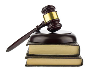 Wooden gavel with books isolated on a white background close-up.