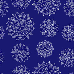 Seamless pattern with hand drawn mandalas, the white outline on the background of trend phantom blue