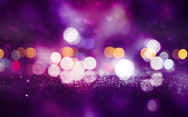 Hearts on a sparkling shiny background. Red abstract background. Blurry bokeh, neon light.