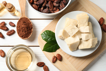 Flat lay composition with organic cocoa butter on white wooden table