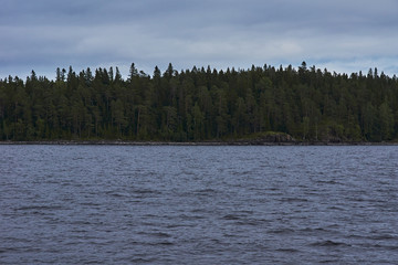 The nature of Karelia.Typical Karelian landscape on the island of Valaam: forest of conifers, Lake Ladoga, crag and volcanic rocks. Russia, Karelia
