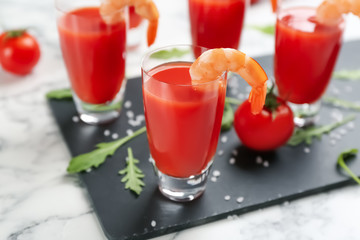 Shrimp cocktail with tomato sauce served on slate board