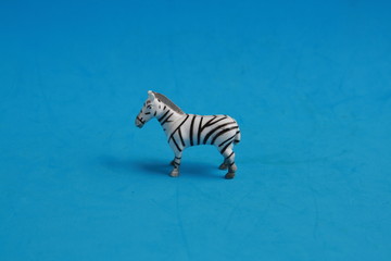 Fototapeta na wymiar plastic toy with zebra shape in color background