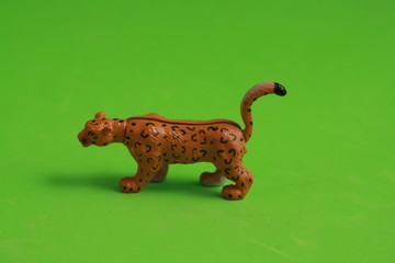 plastic toy with leopard shape in color background