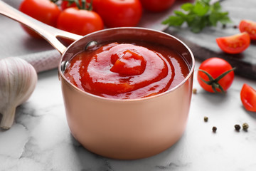 Delicious fresh tomato sauce on marble table, closeup