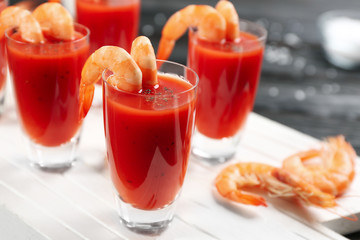 Delicious shrimp cocktail with tomato sauce served on table, closeup