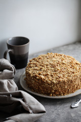 Traditional Russian honey cake on a plate on a gray background. For a calendar, for a recipe book, for posters.