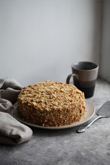 Traditional Russian honey cake on a plate on a gray background. For a calendar, for a recipe book, for posters.