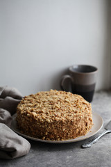 Traditional Russian honey cake on a plate on a gray background. For a calendar, for a recipe book, for posters.