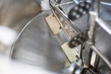 Stainless tank with stirrer for food production.